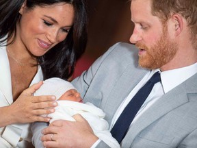 Britain's Prince Harry, Duke of Sussex (R), and his wife Meghan, Duchess of Sussex, pose for a photo with their newborn baby son in St George's Hall at Windsor Castle in Windsor, west of London on May 8, 2019.