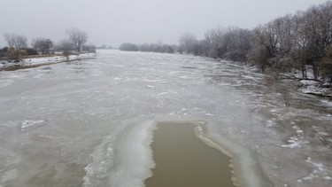 Water levels on the Thames River, seen here looking west from the Prairie Siding bride in Chatham-Kent has dropped 1.3 metres since a state of emergency was called on Friday, prompting the municipality to end its state of emergency Tuesday. (Trevor Terfloth/Postmedia News)