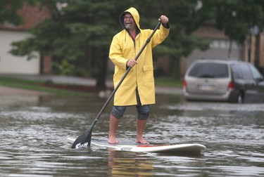 Dave Severs floats down Kimberly Drive in Tecumseh, Ontario on September 29, 2016.   Heavy flooding has hit SW Ontario.  (JASON KRYK/Windsor Star)
