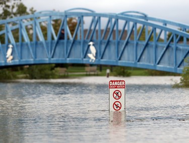 WINDSOR, ONTARIO - SEPT 29, 2016 - A warning sign is seen at Blue Heron Park during flooding in east Windsor on September 29, 2016.  (JASON KRYK/Windsor Star)