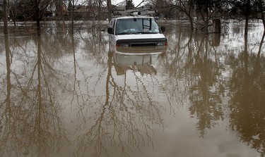 CHATHAM, ONT. FEBRUARY 16, 2009. A truck sits partially sugmerged in flood water February 16, 2009, in Chatham, ON. The rising waters of the Thames river started to subside Monday but not before causing alot of headaches for people along the waterway. ( Dan Janisse / Windsor Star ) ( For story by Don McArthur )