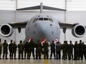 Members of 429 Transport Squadron stand in front of their most-travelled CC-177 Globemaster III transport plane Wednesday, October 17, 2018 at CFB Trenton, Ont. (Luke Hendry/Postmedia Network)