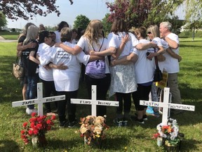 Families of inmates who died at Elgin Middlesex Detention Centre gather at the memorial crosses facing Exeter Road before Lynn Pigeau embarked on her walk to Queens Park to raise awareness about chronic issues at the troubled jail.