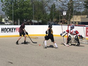 Lucas Biebold, left, of the Lambeth Legends faces off against Deszi OLeary-Pippo of The Wild West at HockeyFest at the Western Fair District this weekend. The two-day road hockey tournament, started by London-based Jones Entertainment Group, has attracted nearly 100 teams.