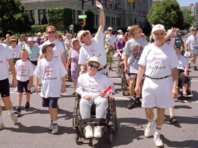 A crowd in downtown London cheers John and Jesse Davidson in 1995 during their fundraising trek across Ontario. (File photo)