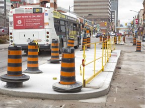 Construction has begun on dedicated bicycle lanes on King Street in London, Ont. on Friday April 12, 2019. Concrete platforms are being installed on the road at bus stops. Cyclists will travel on the right side while buses will stop on the left to board passengers that will be waiting on the platforms. The bicycle lane will run from Ridout Street to Colborne Street. (Derek Ruttan/The London Free Press)