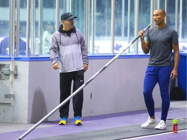 Decathlete Damian Warner talks to his coach Gar Leyshon during pole vault practice in Western University's Thompson Arena in London on Wednesday. (Mike Hensen/The London Free Press)