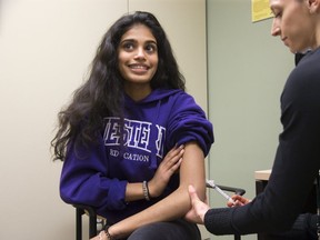 Registered nurse Stephanie McKee administers the chicken pox vaccine to sixteen year old Rachel Rajaratnam at the London Middlesex Health Unit in London. (Derek Ruttan/The London Free Press)