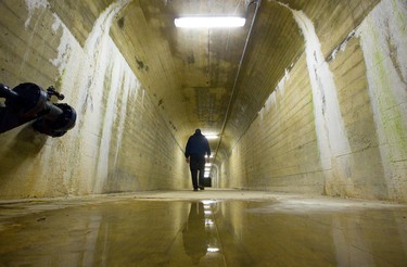 Jeff Cantelon, a dam maintenance worker for the Upper Thames River Conservation Authority (UTRCA), walks through an inspection tunnel in Fanshawe Dam 30 metres below the road surface. These tunnels allow inspection of the dam constructed in 1950-1952 at a cost of $5 million (structure and land). Photograph taken on Friday May 3, 2019.  Mike Hensen/The London Free Press/Postmedia Network