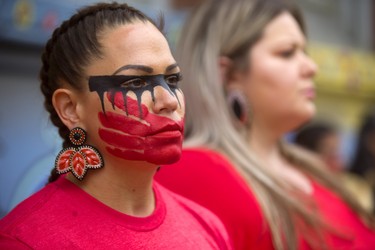 Wearing war paint, with a red hand across her mouth, signifying the lack of voice for the indiginous women who are being trafficked across Canada, Vanessa Ambtman-Smith was at the silent protrest in front of Atlohsa Ð Family Healing Services on Richmond Street in London. (Mike Hensen/The London Free Press)