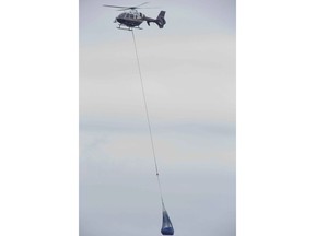 An OPP helicopter lifts a refrigerator from the beach below a Lake Erie bluff east of Port Burwell on Tuesday, May 7, 2019. Earlier, the helicopter lifted a body from the beach off Lakeshore Line east of Stafford Road. Derek Ruttan/The London Free Press