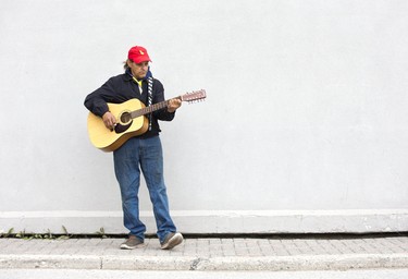 Daniel Crow busks for pedestrians on York St. in London, Ont. on Friday May 10, 2019. Crow says he has 400 songs memorized and let's fate decide which ones he performs "Whatever my hands start playing is the song I play," he chuckled.  Derek Ruttan/The London Free Press/Postmedia Network