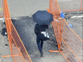 A pedestrian traverses a section Dundas Street that is being converted to a flex street in London, Ont. on Monday May 13, 2019. Derek Ruttan/The London Free Press/Postmedia Network