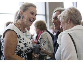 Kathy Luongo, left, a Woman of Excellence award recipient in the category of Community and Volunteerism, chats with friends Sandi McCabe and Bonnie Adamson prior to the awards dinner the London Convention Centre   in London on Wednesday. "She's such a wonderful person," said McCabe of Luongo. "She's my hero." (Derek Ruttan/The London Free Press)