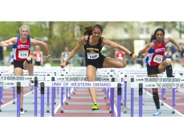 Tayah De Sousa of Central Elgin leads home the junior girls 80m hurdles followed by Chloe Adolphe, right, for silver and Lily Francis both of St. Andre Bessette for bronze at the TVRA track and field meet held on Wednesday at TD Stadium. (Mike Hensen/The London Free Press)