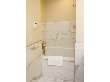 To save space a bath is tucked into a space that makes for a narrower entrance but room behind the wall for the tub, allowing a full size shower and tub in a small bathroom floorplan at 312 Wolfe St.  (Mike Hensen/The London Free Press)