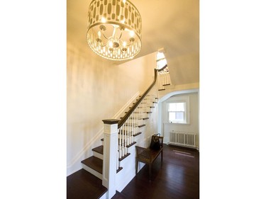 The front stairwell shows off a beautiful staircase and cabinetry at 618 Wellington St.   (Mike Hensen/The London Free Press)
