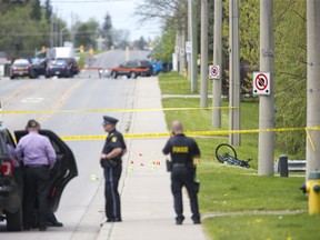 Police gather evidence at the scene of cyclist being struck by a vehicle on Broadway at Christie Street  in Tillsonburg, Ont. on Tuesday May 21, 2019. Derek Ruttan/The London Free Press/Postmedia Network