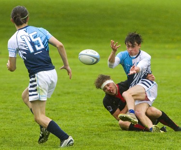 Lucas' Noah Dubroy passes the ball as he's tackled by Medway's Jacob Ursic during their varsity boys rugby game at AB Lucas.
Medway, rated number one in Ontario and last year's OFSAA champion started fast with a 31-0 first half, before shutting it down a little in the second for a 38-0 win.
Photograph taken on Wednesday May 22, 2019. 
Mike Hensen/The London Free Press/Postmedia Network