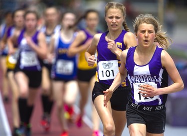 Abigal Kraayenbri, of F.E. Madill secondary school in Wingham, set the pace early in the junior girls' 1,500m, but couldn't shake Hallee Knelsen, of East Elgin, who slotted in behind her for two laps before Knelsen took the lead in the penultimate lap and then broke away for a solo win Thursday, May 23, 2019 during Day 1 of the WOSSAA track and field meet at TD stadium in London.  Mike Hensen/The London Free Press