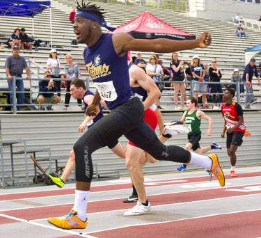 Gaddy Kazadi of Regina Mundi secondary school wins the senior boys' 100m race into a headwind at WOSSAA with a time of 11.41 seconds Thursday May 23, 2019 at TD stadium in London.  Mike Hensen/The London Free Press