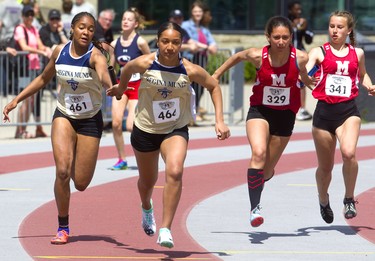 Teams from Regina Mundi and Medway secondary schools make the  final handoff in the girls' 4x100m relays during  Day 1 of the WOSSAA track and field meet Thursday May 23, 2019 at TD stadium in London.  Mike Hensen/The London Free Press