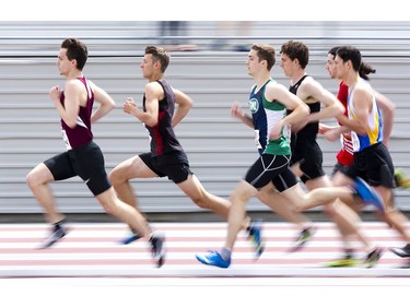 Senior boys run in the 3000m race during the WOSSAA track and field championship at TD Stadium in London on Friday. (Derek Ruttan/The London Free Press)