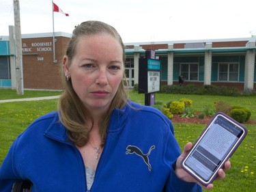 Stephanie Burt, is angry that her four-year-old daughter Lilly has been injured at school by another student and nothing seems to be done to stop another attack at F.D. Roosevelt elementary school in London. Burt is holding her phone with an app that the school board uses to communicate with parents, and how she found out about the attack. (Mike Hensen/The London Free Press)