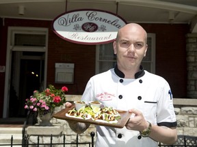 Villa Cornelia chef Ryan Hancock holds up a plate of pork belly tacos in London, his restaurant's entry in Signatures: A Taste of London's Best, a fundraiser for the Parkinson Society Southwestern Ontario. (Derek Ruttan/The London Free Press)