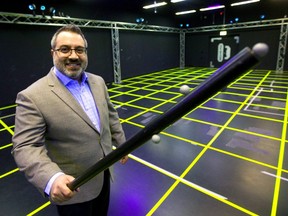 Chady Boutros, the owner of Dreamland VR, says that with added sensors their gameplay continues to improve with actual props like a torch he's holding that bears its own motion sensors.  (Mike Hensen/The London Free Press)