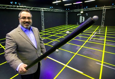 Chady Boutros, the owner of Dreamland VR, says that with added sensors their gameplay continues to improve with actual props like a torch he's holding that bears its own motion sensors.  (Mike Hensen/The London Free Press)