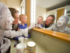 Alastair Knowles, left, and his partner Stephanie Morin-Robert play in the mirror with their 15-month-old daughter Olive as Knowles applies makeup for his show Ink at the London Fringe Festival. Morin-Robert and Olive also have a show in the Fringe, Eye Candy. (Mike Hensen/The London Free Press)