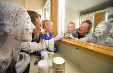 Alastair Knowles, left, and his partner Stephanie Morin-Robert play in the mirror with their 15-month-old daughter Olive as Knowles applies makeup for his show Ink at the London Fringe Festival. Morin-Robert and Olive also have a show in the Fringe, Eye Candy. (Mike Hensen/The London Free Press)