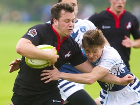 Lucas's Noah Dubroy tries to wrap up Medway's Brant Galbraith during the WOSSAA final in boys rugby held on May 30, 2019 at St. George's Fields in London. (Mike Hensen/The London Free Press)