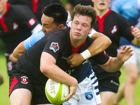 Lucas's Mike Chann tackles Medway's Brant Galbraith who passes the ball away underhanded during the WOSSAA final in boys rugby held at St. George's Fields in London on May 30, 2019. (Mike Hensen/The London Free Press)