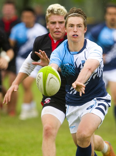 Lucas's Mackenzie Baker passes just before being hit by Medway's Jake Amos during the WOSSAA final in boys rugby held at St. George's Fields in London on Thursday. Medway, the No. 1 team in the province, wrapped up another WOSSAA championship 55-12, after a strong 43-0 first half set the tone of the game. Medway heads to OFSAA in Oshawa next week. (Mike Hensen/The London Free Press)