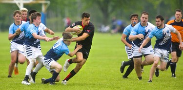 Lucas' Adam Cebulski is the first player to Medway's Connor Badeen as Badeen has a big hole during the WOSSAA final in boys rugby held at St. George's Fields in London on Thursday. Medway, the No. 1 team in the province, wrapped up another WOSSAA championship 55-12, after a strong 43-0 first half set the tone of the game. Medway heads to OFSAA in Oshawa next week. (Mike Hensen/The London Free Press)
