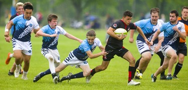Lucas's Adam Cebulski is the first player to Medway's Connor Badeen as Badeen has a big hole during the WOSSAA final in boys rugby held at St. George's Fields in London on Thursday. Medway, the No. 1 team in the province, wrapped up another WOSSAA championship 55-12, after a strong 43-0 first half set the tone of the game. Medway heads to OFSAA in Oshawa next week. (Mike Hensen/The London Free Press)