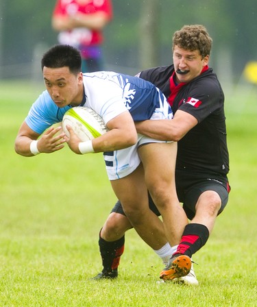 Lucas's Mike Chann is tackled by Medway's Tye Johnson after catching a pass during the WOSSAA final in boys rugby held at St. George's Fields in London on Thursday. Medway, the No. 1 team in the province, wrapped up another WOSSAA championship 55-12, after a strong 43-0 first half set the tone of the game. Medway heads to OFSAA in Oshawa next week. (Mike Hensen/The London Free Press)