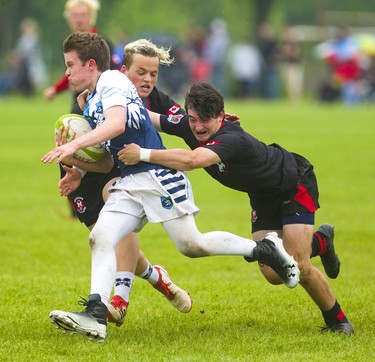 Medway's Kearnan Jenney and Noah Coleman converge on Lucas's Jake Ashton during the WOSSAA final in boys rugby held at St. George's Fields in London on Thursday. Medway, the No. 1 team in the province, wrapped up another WOSSAA championship 55-12, after a strong 43-0 first half set the tone of the game. Medway heads to OFSAA in Oshawa next week. (Mike Hensen/The London Free Press)
