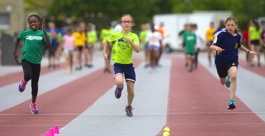 Elliott Nash, 10, comes up the middle to win her 50m dash at the London District Catholic school board elementary track and field meet being held this week at TD Stadium in London on Friday. At left is Fiona Kalaiwo of St. Theresa and on the right is Zoe Morin of Ste-Jeanne-d'Arc. (Mike Hensen/The London Free Press)