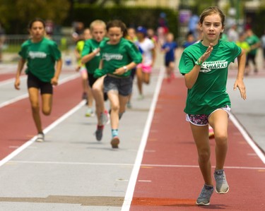 Avery Stewart, 10, of St. Theresa in Byron leads a strong contingent of St. Theresa runners who took the first four places across the line in the 400m portion of the track triathlon held as part at the London District Catholic school board elementary track and field meet being held this week at TD Stadium in London on Friday. The triathlon includes 400m, standing long jump and softball throw. (Mike Hensen/The London Free Press)