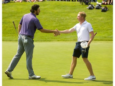 Charles Fitzsimmons, left, the final player for Western, needed to birdie the 18th, which was the first playoff hole for the men's team division in the Canadian University/College Championshiop at FireRock Friday, and hope that his competitor Andrew Harrison of UBC bogied. Fitzsimmons left his putt a good four to five feet short, and when Harrison drained his par putt, there was nothing to do but shake hands. Fitzsimmons did win the singles men's competition over teammate Jackson Bowery also on the first playoff hole. (Mike Hensen/The London Free Press)