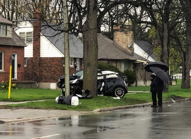 London police officers inspect the scene of a Tuesday morning crash on Clarke Road, just north of Dundas Street. JONATHAN JUHA/THE LONDON FREE PRESS