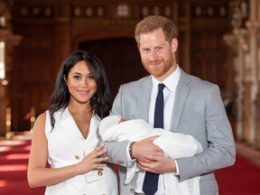 Britain's Prince Harry, Duke of Sussex (R), and his wife Meghan, Duchess of Sussex, pose for a photo with their newborn baby son in St George's Hall at Windsor Castle in Windsor, west of London on May 8, 2019. (Photo by Dominic Lipinski / POOL / AFP)