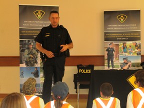 OPP Const. Chris Doupe gives a talk to children about personal safety during the Lambton Farm Safety Association's Progressive Agriculture Safety Day in Brigden last summer. Postmedia file photo