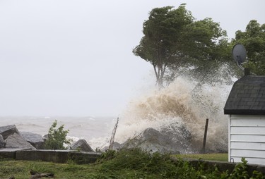 LEAMINGTON, ONT.: JUNE 27, 2015 -- High waves crash onto the front yard of a property on Coterie Park, Saturday, June 27, 2015.  High waves and rain flooded the road just outside of Wheatley.  (DAX MELMER/The Windsor Star)