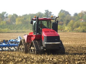 A farmer uses a quadtrak Case 600hp tractor to haul his disc harrow through a wet and muddy corn field north of Coldstream, Ont., on Monday October 8, 2018. (Mike Hensen/Postmedia Network)