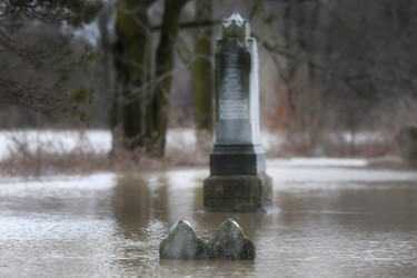 THAMESVILLE, ON. FEBRUARY 23, 2018. -- Flood waters cover grave markers in a cemetery along the Thames River in Thameville, ON. on Friday, February 23, 2018. (DAN JANISSE/The Windsor Star)