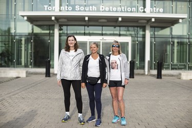 Toronto, ONT.: May 30, 2019 -- Left to right; Rebecca McLean, Lynn Pigeau, and Lisa Hennessey, in front of Toronto South Detention Centre on their walk from London to Toronto to bring attention to deaths (including those of their loved ones) in correctional facilities. They hope their walk will bring changes to corrections in Ontario. Toronto, Ont., May 30, 2019. (Nick Kozak for Postmedia News). ORG XMIT: POS1905301825000774